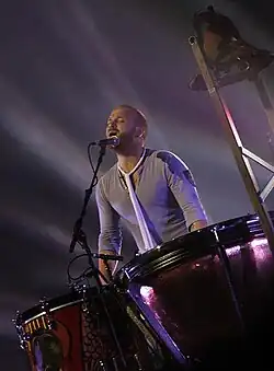 Champion plays the drums for "Viva la Vida" during the Viva la Vida Tour in 2009.