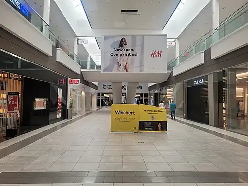 An advertisement for Weichert, Realtors in Wayne, New Jersey's Willowbrook Mall, 2024.