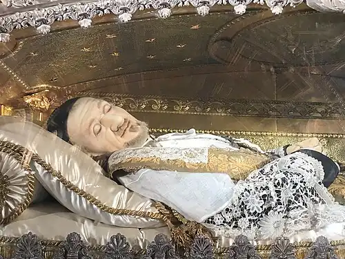 The waxen mask and hands encasing Vincent's bones