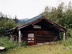 The log-built post office at Wiseman, seen here in 1995, has been sinking into the ground for the past century, and is now a couple of feet below ground.