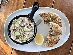 Cold Dungeness crab dip served cucumber, onions and a side of pita bread
