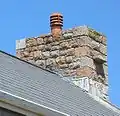 This modern house incorporates witches' stones in its chimneys