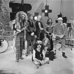 Wizzard in May 1974. Standing from left to right: Roy Wood, Keith Smart, Nick Pentelow, Mike Burney, Rick Price. Sitting from left to right: Charlie Grima, Bob Brady