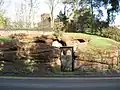 The sign next to the entrance says "Wolverley Pound, formerly used for impounding animals found straying until ransomed by their owners".[20]