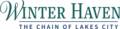 Winter Haven in a green serif font on top except for a cursive W, "The Chain of Lakes City" on bottom in an italicized sans serif font
