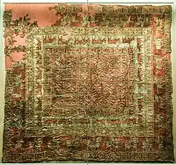 Decorated carpet from Pazyryk-5, of Near-Eastern origin. This is the earliest surviving knotted-pile carpet.[38]