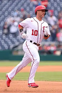 Yan Gomes running around the bases in a white Washington Nationals uniform