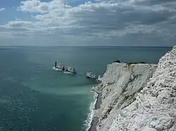 Color photograph of white cliffs and sea rocks