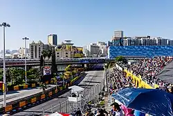 View of Macau skyline over circuit and grandstands in 2023