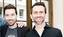 Zach Lipovsky (left) and Adam Stein (right) looking at the camera and smiling