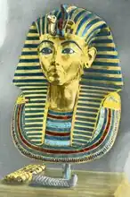 The mask on display at Cairo Museum with the necklace and beard placed separately,  1938