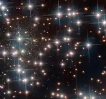 Galaxy nicknamed Bedin I is located behind the bright stars of the cluster.[13]