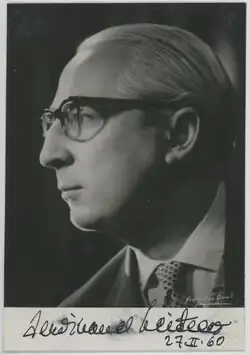 A black and white photograph of a man in profile, with an autograph dedication