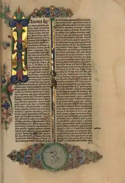 Photograph of written Latin text embellished with gold and intricate colourful designs