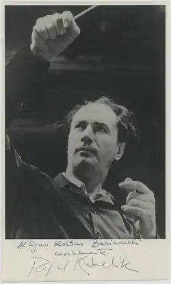 A black and white photograph of a man conducting