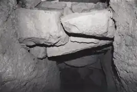 Inside the passage, looking up, seeing entrance stones and upper tunnel