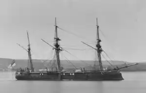 Black and white photo of Amazon from the side, showing her three masts and one funnel.