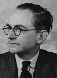 Headshot of man wearing spectacles with head turned to his right