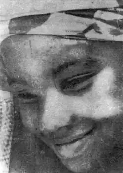 A candid black and white photo of Aline Sitoe Diatta, who is looking down and smiling