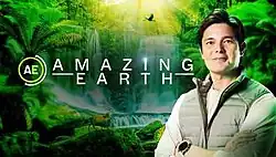 An image of Dingdong Dantes, with plants and waterfalls on the background. The show title is displayed on the upper side of the image. The letters A and E are written inside a circle in the left side of the image.