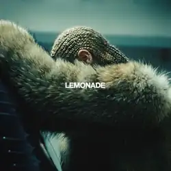 Beyonce wearing cornrows and a brown fur coat, leaning against a car with her arm obscuring her face; the title "Lemonade" is overlaid in white text in the center of the image.