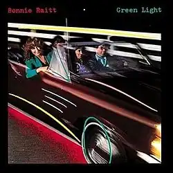 photo of band in maroon car in motion with Bonnie Raitt in passenger seat with geometric art added