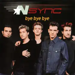 The five band members are facing towards the center, in front of a black background. The song's title is above them.