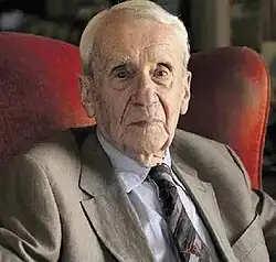 photograph of Christopher Tolkien, an elderly white man, seated and wearing a jacket and tie