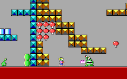 Side view of Commander Keen facing a Martian Garg enemy, surrounded by a structure composed of square blocks