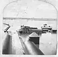 Council Bluffs Transfer Depot outbuildings in the flood of 1881. The outbuilding housed the emigrant hotel, the bakery, laundry rooms, land office, and the freight cold storage warehouse.
