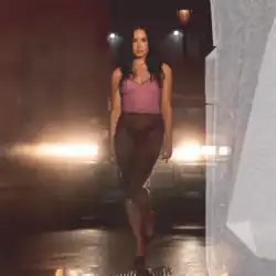 Lovato walking in front of a car shining its headlights
