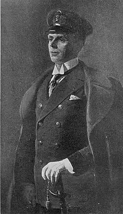 middle-aged, clean shaven white man in semi profile, wearing the uniform of a Royal Navy officer with and open coat, white gloves and a sword