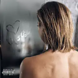 A topless Gabbie Hanna looking through a see-through shower door, on which a message has been left on the steam.