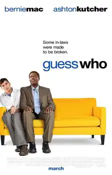 A thin white man, and a large black man are seated close together on a large yellow couch