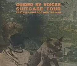 A black-and-white photo of a child holding a cat, with the child's face obscured by ink
