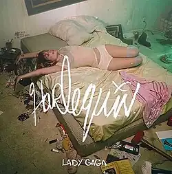 Lady Gaga laying on a mattress in a disheveled room