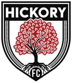 A black on white shield depicting a red hickory tree.