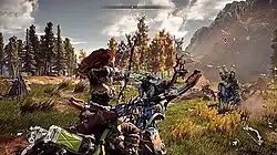A red headed girl aims a bow and arrow at a mechanical elk