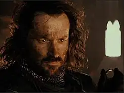 Harry Sinclair as Isildur in Peter Jackson's The Fellowship of the Ring, holding the One Ring after cutting it from the hand of Sauron