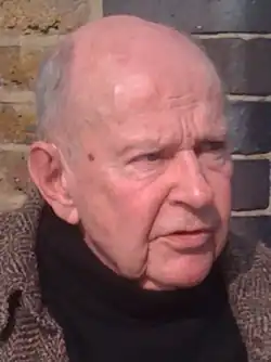 Face of Golding: an older man, balding, wearing a tweed jacket and a black turtleneck sweater