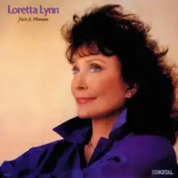 photo of Loretta Lynn in purple top looking off-camera
