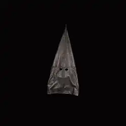 A white Ku Klux Klan hood against a pitch black backdrop.