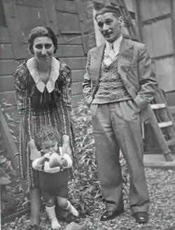 Black and white photo of Greenman and his wife with their young son