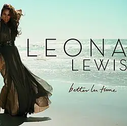 A brunette woman stands in front of a beach. She wears a dress and she grabs the back of her neck with her left arm. Next to her image, the words "Leona Lewis" are written in capital letters, and "Better in Time" in italics.