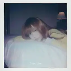 Polaroid-filtered Lilas Ikuta lying on a bed with a white frame