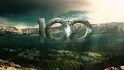 CGI letters "100" over a dry landscape