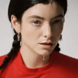 Cover art for "What Was That": Lorde, styled in braids and a red shirt, with water running down her chin