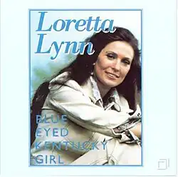 framed photo of Loretta Lynn over light blue background