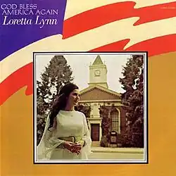 framed photo of Loretta Lynn in white on US flag background
