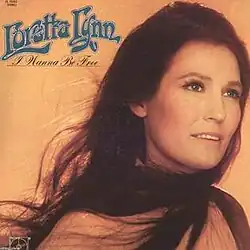 duotone orange black photo of Loretta Lynn